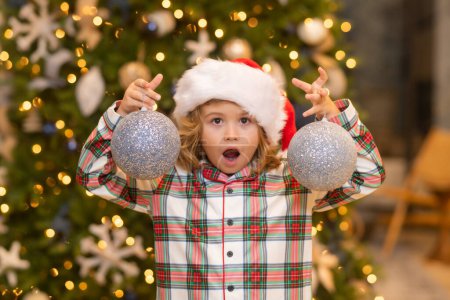 Téléchargez les photos : Enfant à la maison à Noël. Petit enfant célébrant Noël ou Nouvel An - en image libre de droit