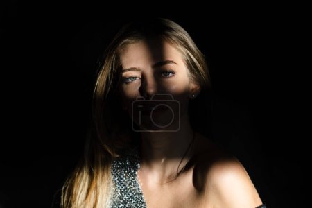 Photo for Portrait of beautiful woman model looking seductive and sensual. Beauty face with dramatic studio light isolated on black. Passion girl, charming tender female model. Beauty salon - Royalty Free Image
