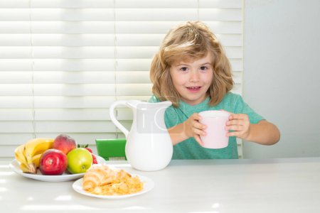 Photo for Portrait of preteen child eat fresh healthy food in kitchen at home. Kid boy eating breakfast before school. Vitamin and nutrition protein for kids - Royalty Free Image