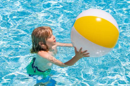 Foto de Child in swimming pool on inflatable ring. Kid swim with orange float. Water toy, healthy outdoor sport activity for children. Kids beach fun - Imagen libre de derechos