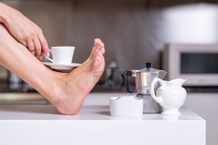 Photo for Sexy woman legs with cup coffee, close up - Royalty Free Image
