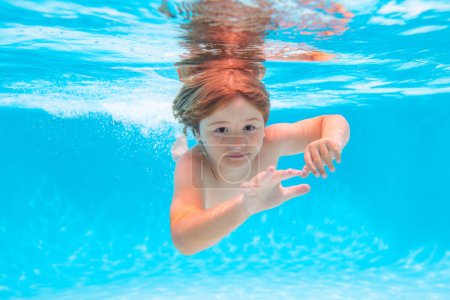 Photo for Child swim and dive underwater in the swimming pool. Summer kids in water in pool underwater - Royalty Free Image