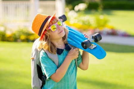 Photo for Summer kids fashion. Kid with skateboard. Child hold skate board. Healthy sport and activity for school kids in summer. Sports fun - Royalty Free Image
