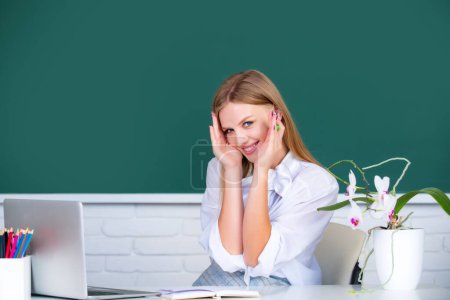 Photo for Beautiful student, cute blonde embarrassed, young woman in class at school - Royalty Free Image