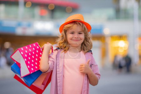 Photo for Shopping kids at fashion store. Fashion kid with shopping bag outdoor. Little shopper child - Royalty Free Image