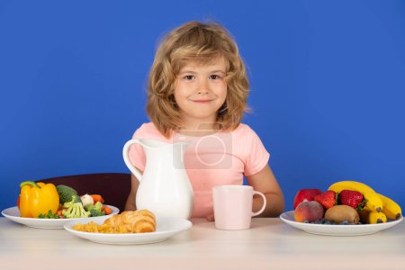 Photo for Kid with dairy milk. Child with milk is poured from a jug into a glass - Royalty Free Image