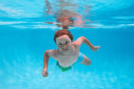 Téléchargez les photos : Summer kids in sea water on beach. Underwater child swims in pool, healthy child swimming and having fun under water - en image libre de droit