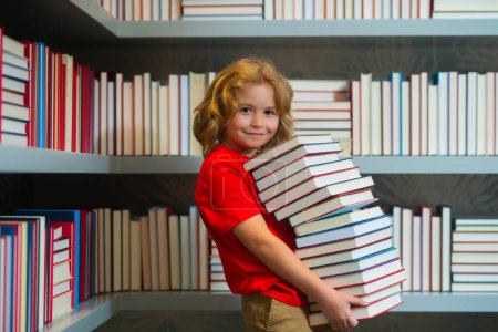 Photo for Back to school. Schoolboy reading book in library. Kids development. Pupil learn to read. Child from elementary school read books in a book store - Royalty Free Image