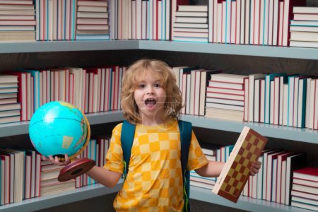 Photo for School boy with world globe and chess, childhood. Nerd pupil. Clever child from elementary school with book. Smart genius intelligence kid ready to learn - Royalty Free Image