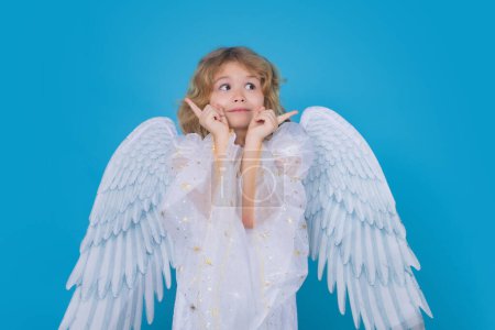 Foto de Cute angel kid, studio portrait. Blonde curly little angel child with angels wings, isolated background - Imagen libre de derechos