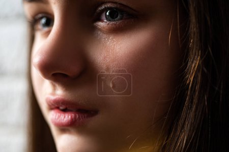 Photo for Kid crying with a tear on cheek. Close up kid crying with tearful on face - Royalty Free Image