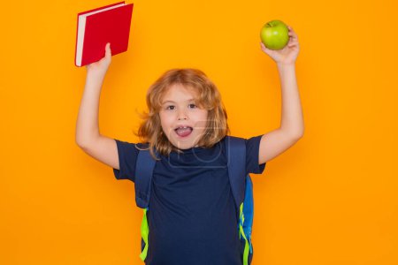 Foto de Smart child, clever school kid. Schoolboy with book isolated on yellow background. Elementary school kids. Pupil go study. Clever schoolboy learning. Kids study, knowledge and education concept - Imagen libre de derechos