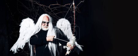 Foto de Valentines Day banner. Man in angel costume. Angel man with feather white wings and gift. Satan on Hell. Bearded old man dressed like Halloween monster. Man evil with horns - Imagen libre de derechos