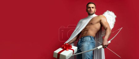 Photo for Valentines Day banner. Sexy guy with angels wings. Cupid. Amour. February 14. Arrow of love. Isolated on red. Banner flyer template for advertising for header design - Royalty Free Image