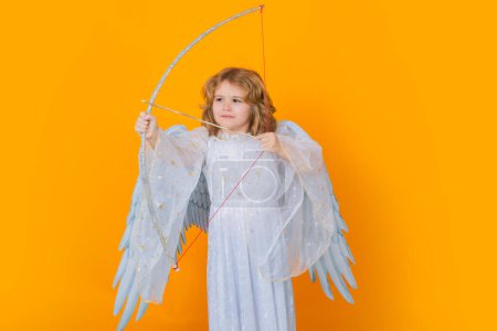 Photo for Angel with bow and arrow. Little angel. Portrait of cute kid with angel wings isolated on studio background. Little angel, valentines day. Angelic kids - Royalty Free Image