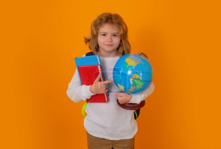 Photo for Back to school. School kid with globe and book. Smart clever nerd. Caucasian blonde school boy kid pupil student going back to school. Education and knowledge - Royalty Free Image