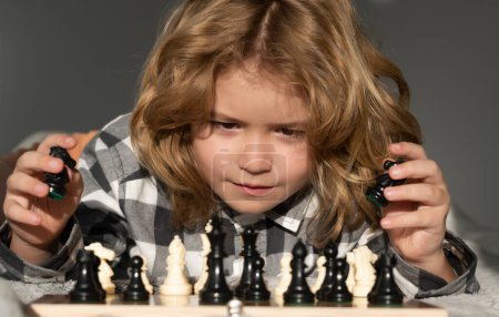 Photo for Clever thinking child. Kid playing chess. Clever child thinking about chess. Kids early development - Royalty Free Image