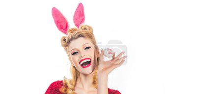Téléchargez les photos : Lovely woman in rabbit costume. Lovely woman in rabbit costume. Hunting eggs. Pretty girl hunts for Easter eggs. Sweet adorable girl in bunny ears celebrating Easter. Panoramic web banner frame - en image libre de droit