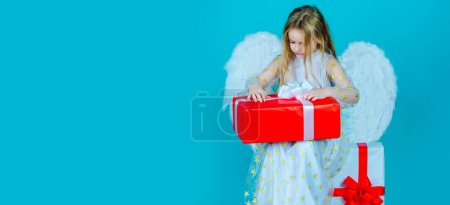 Photo for Valentines day banner with angel child. Valentines Day. Little angel girl open gift. Cute child girl posing with angel wings. Angel child from heaven gives you gift - Royalty Free Image