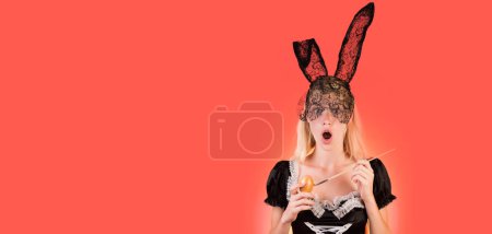 Photo for Happy young woman wearing bunny ears and having Easter Eggs copy space. Crazy people. Woman easter. Beautiful sensual blonde. Easter banner, mockup copy space, poster header for website template - Royalty Free Image