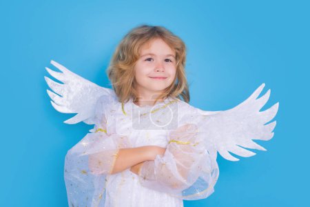Foto de Child at angel costume. Kid with angel wings. Isolated studio shot - Imagen libre de derechos