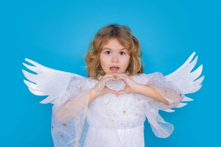 Photo for Little angel. Portrait of cute kid with angel wings isolated on blue studio isolated background. Little angel, valentines day. Angelic kids - Royalty Free Image