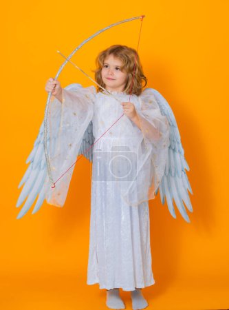 Photo for Angel with bow and arrow. Valentine angel. Little cupid child. Kid angel with angels wings, isolated on yellow studio background. Valentines day gift card - Royalty Free Image