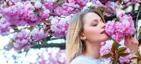 Photo for Sensual woman near sakura tree background, banner for website header.Passion and sensual touch. Beauty spring girl with blooming sakura cherry Flover - Royalty Free Image