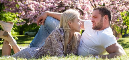 Photo for Couple in love, spring banner. Outdoor portrait of young lovers couple near sakura. Young couple in love - Royalty Free Image