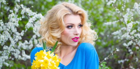Photo for Portrait of sensual woman in spring background. Banner for website header. Beautiful spring girl in blooming tree. Spring face fresh. Young beautiful woman make lipstick - Royalty Free Image