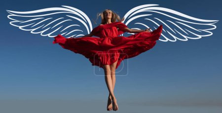 Foto de Angel woman with wings. Valentines day banner for website header design. Movement girl in red dress on sky. Attractive woman in fashion outfit outside - Imagen libre de derechos