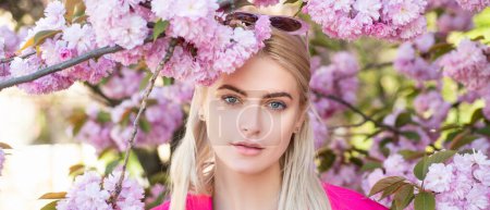 Photo for Sensual woman near sakura tree background, banner for website header. Spring girl. Outdoor portrait of young beautiful happy smiling female model near flowering tree - Royalty Free Image