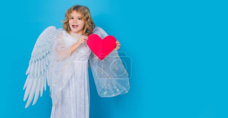 Photo for Child with angel wings hold paper heart. Symbol love and valentines day. Cute angel kid, studio portrait. Banner for header design, flyer template - Royalty Free Image