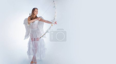 Photo for Valentines day banner with sexy angel woman. Pretty white little girl as the cupid with a bow and arrow congratulating on St Valentines day - Royalty Free Image