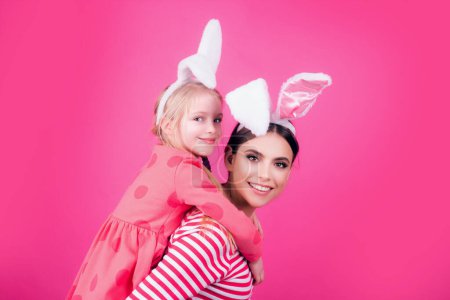 Téléchargez les photos : Joyeux Pâques famille sœur. Oreilles de lapin d'Halloween filles. Les enfants célèbrent Pâques. Chasse aux œufs traditionnelle - en image libre de droit
