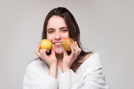 Photo for Portrait of a cheerful young woman hold apple isolated over gray background - Royalty Free Image