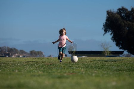Photo for Little kid boy playing football in the field with soccer ball. Concept of children sport. Kids training soccer - Royalty Free Image