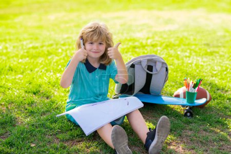 Foto de Little artist drawing painting art in park. Child learning outside in the nature park. Relaxation and childhood concept. Little boy with brush paint painting. Kid artist painter draw pictures oudoor - Imagen libre de derechos
