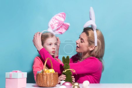 Foto de Family easter. Mom with child are preparing for Easter. Mother and daughter wearing bunny ears. Easter banner, mockup copy space, poster flyer header for website template - Imagen libre de derechos