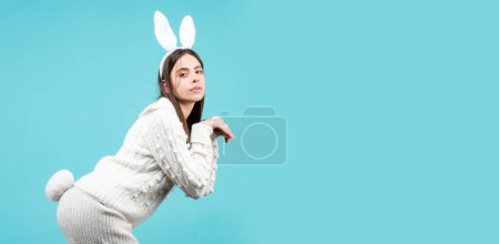 Foto de Horizontal photo banner for website header design. Easter bunny girl. Surprised girl with bunny ears on Easter day. Lovely woman in bunny rabbit costume - Imagen libre de derechos