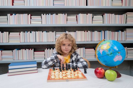 Photo for Chess school for children. Kid thinking about chess. The concept of learning and growing children. Chess, success and winning. Board logic game, kids hobby and lifestyle - Royalty Free Image