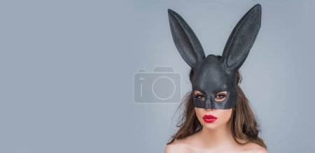 Foto de Easter banner, mockup copy space, poster flyer header for website template. Easter bunny woman in black lace mask. Egg hunt. Rabbit ears - Imagen libre de derechos