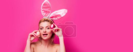 Photo for Woman with Easter eggs. Cute girl wearing bunny ears on Easter day. Horizontal photo banner for website header design - Royalty Free Image