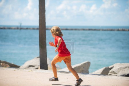 Foto de Healthy sport activity and running for children. Little boy at race. Young athlete in training. Runner exercising. Jogging for kid - Imagen libre de derechos
