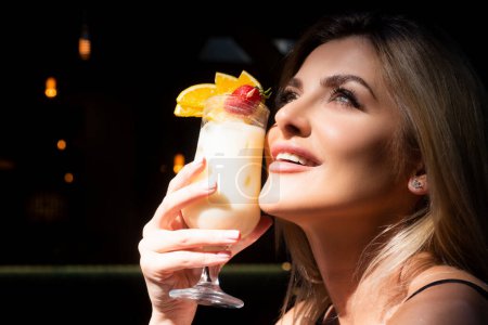 Photo for Close up photo of young happy woman with sensual lips and mouth drinking cocktails. Cocktail menu. Cocktail for young. Bar and restaurant concept. Pina colada - Royalty Free Image