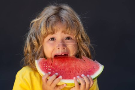 Photo for Kid face and watermelon, close up. Excited child eat watermelon. Kid is picking watermelon on gray background - Royalty Free Image