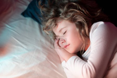 Photo for Kid enjoying sweet dreams. Kid sleeping on bed at home. Bedtime, kids sleeps. Child asleep on pillow, having healthy sleep - Royalty Free Image
