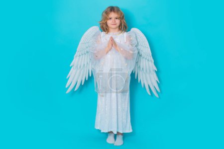 Photo for Angel prayer. Cute angel child, studio portrait. Angel kid with angels wings, isolated background - Royalty Free Image