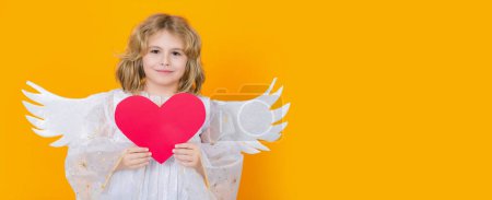 Photo for Angel with heart. Beautiful little angel. Isolated studio shot. Cute Pretty child with angel wings. Banner for header design, flyer template - Royalty Free Image