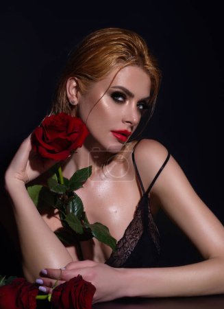 Photo for Sexy woman with red rose. Slim sexy beautiful woman with naked shoulder hold red roses, isolated on studio background. Portrait of sensual girl with flowers - Royalty Free Image